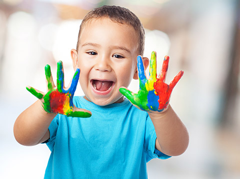 happy little boy with painted hands