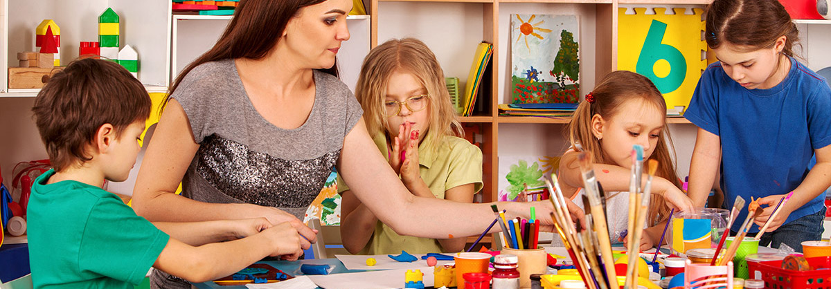 teacher painting with preschool children